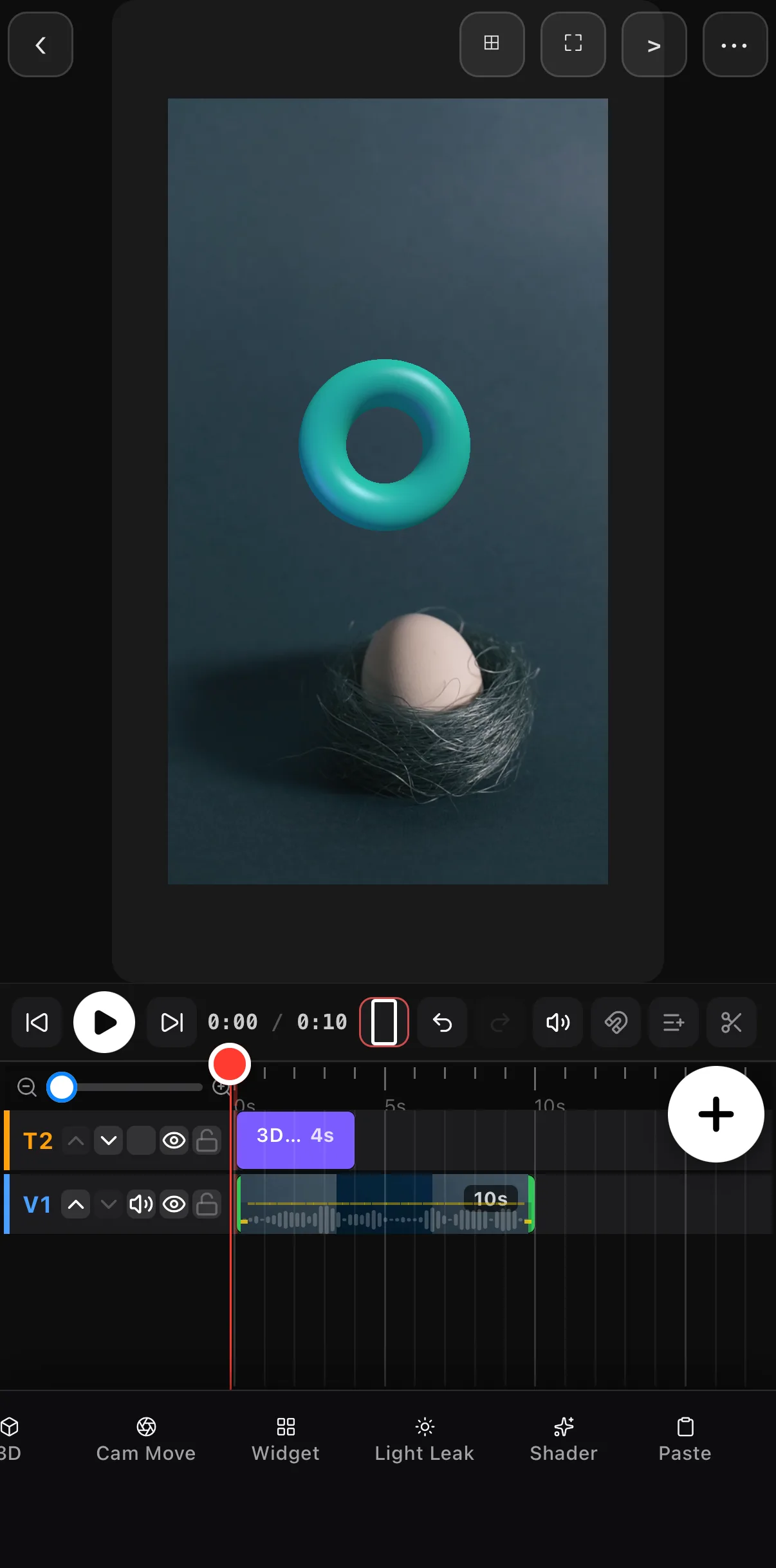 A teal torus floating above an egg in a nest on a dark studio backdrop; the timeline shows a 4-second 3D layer on T2 above the 10-second clip on V1.