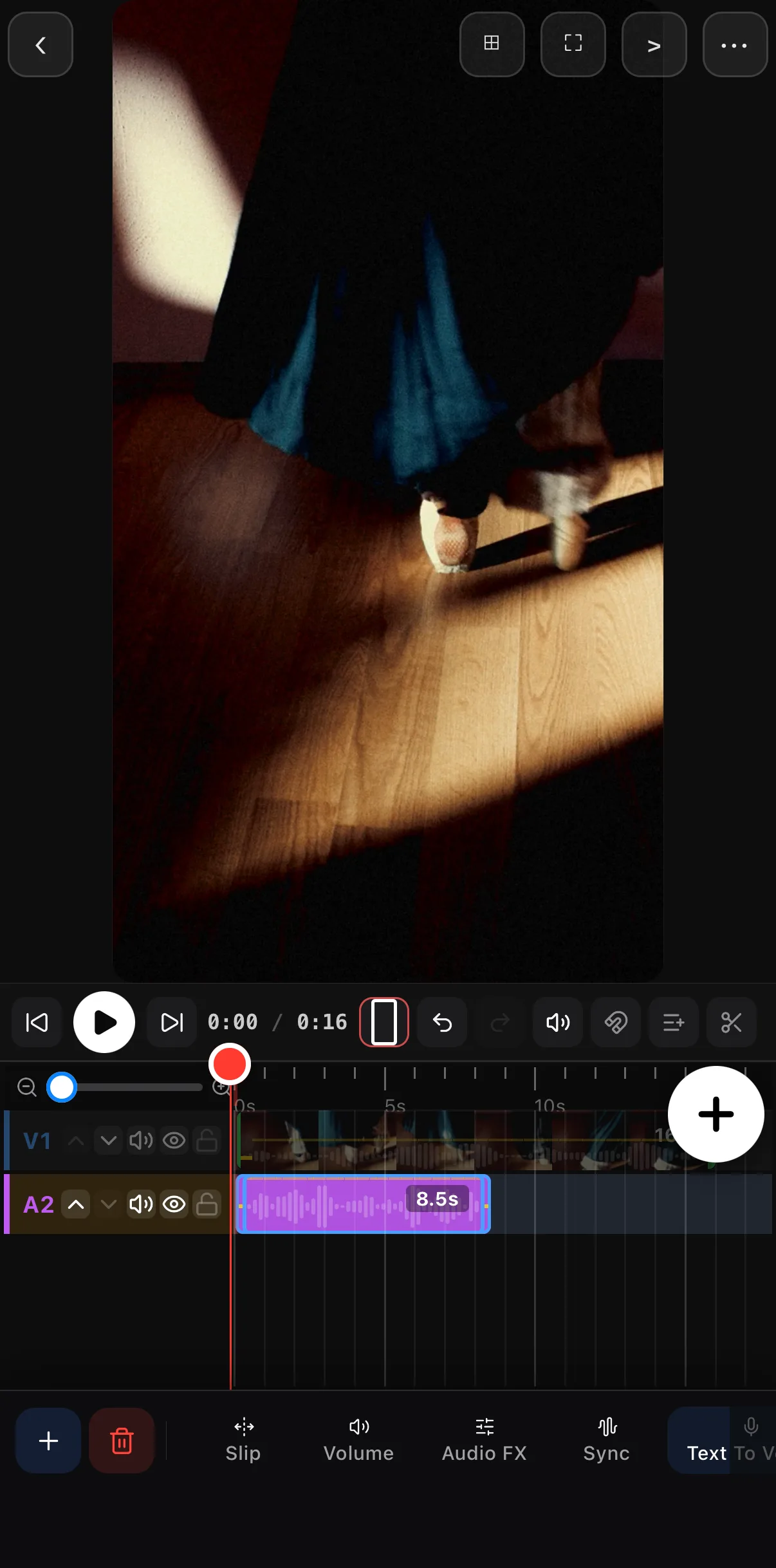 The music clip on the A2 row under the video, selected, with Slip, Volume, Audio FX, Sync and Text To Voice on its toolbar