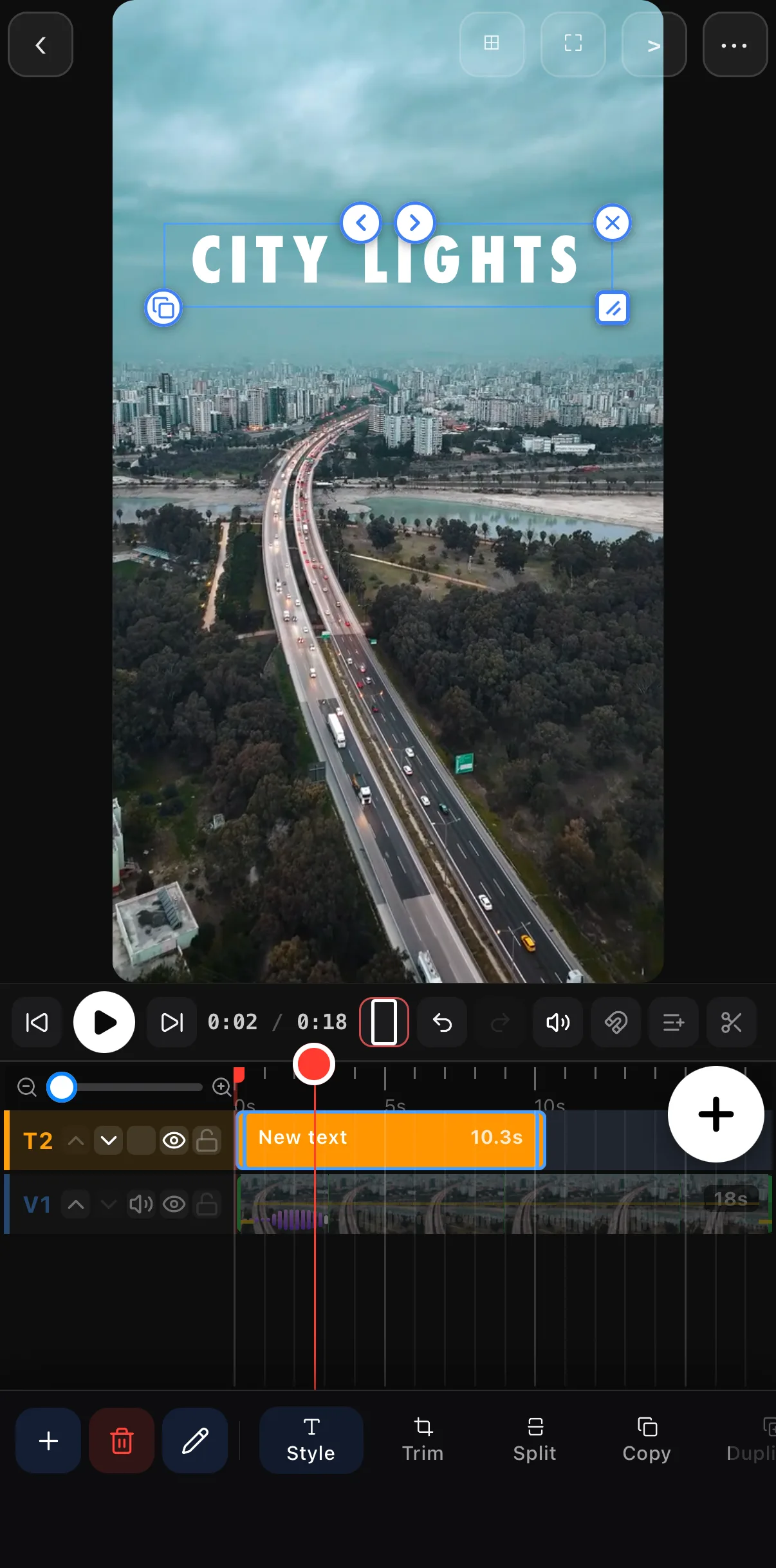 The timeline with the City Lights text clip stretched to 10.3 seconds on its T2 row above the 18-second video on V1
