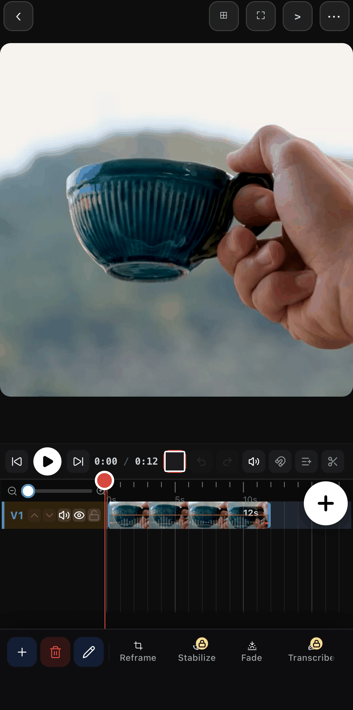 The clip toolbar scrolled to show Reframe, Stabilize, Fade and Transcribe under a square canvas of the mug.