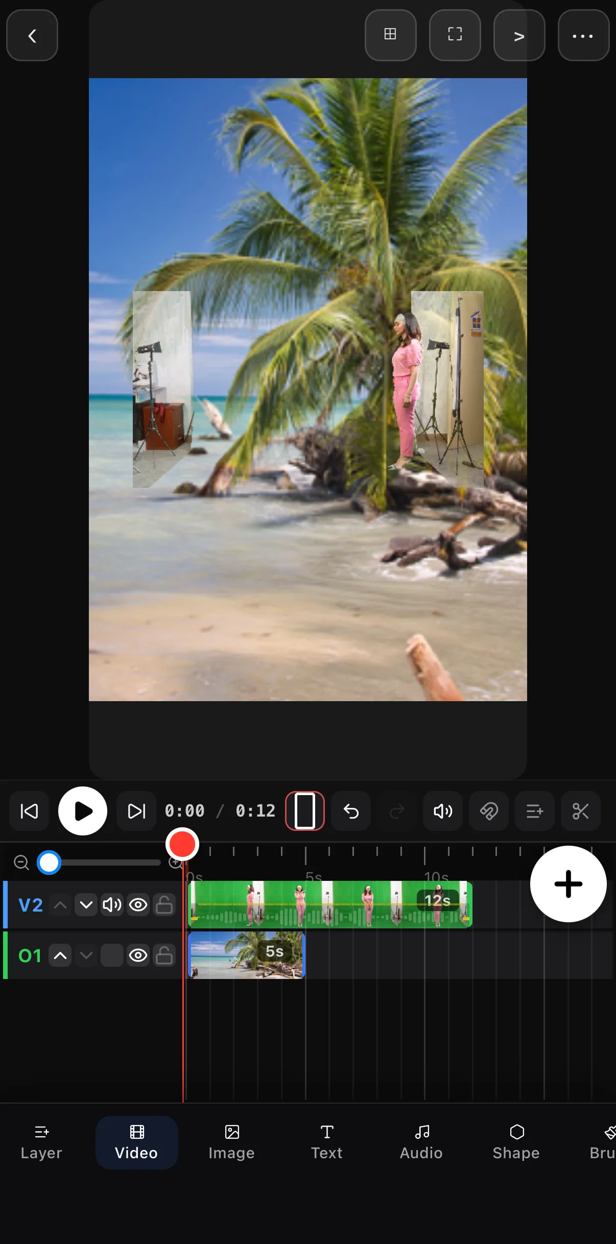 The canvas after Done: the woman in pink stands on the beach photo with the green fully removed; the studio lights and wall at the clip's edges are still visible on either side.