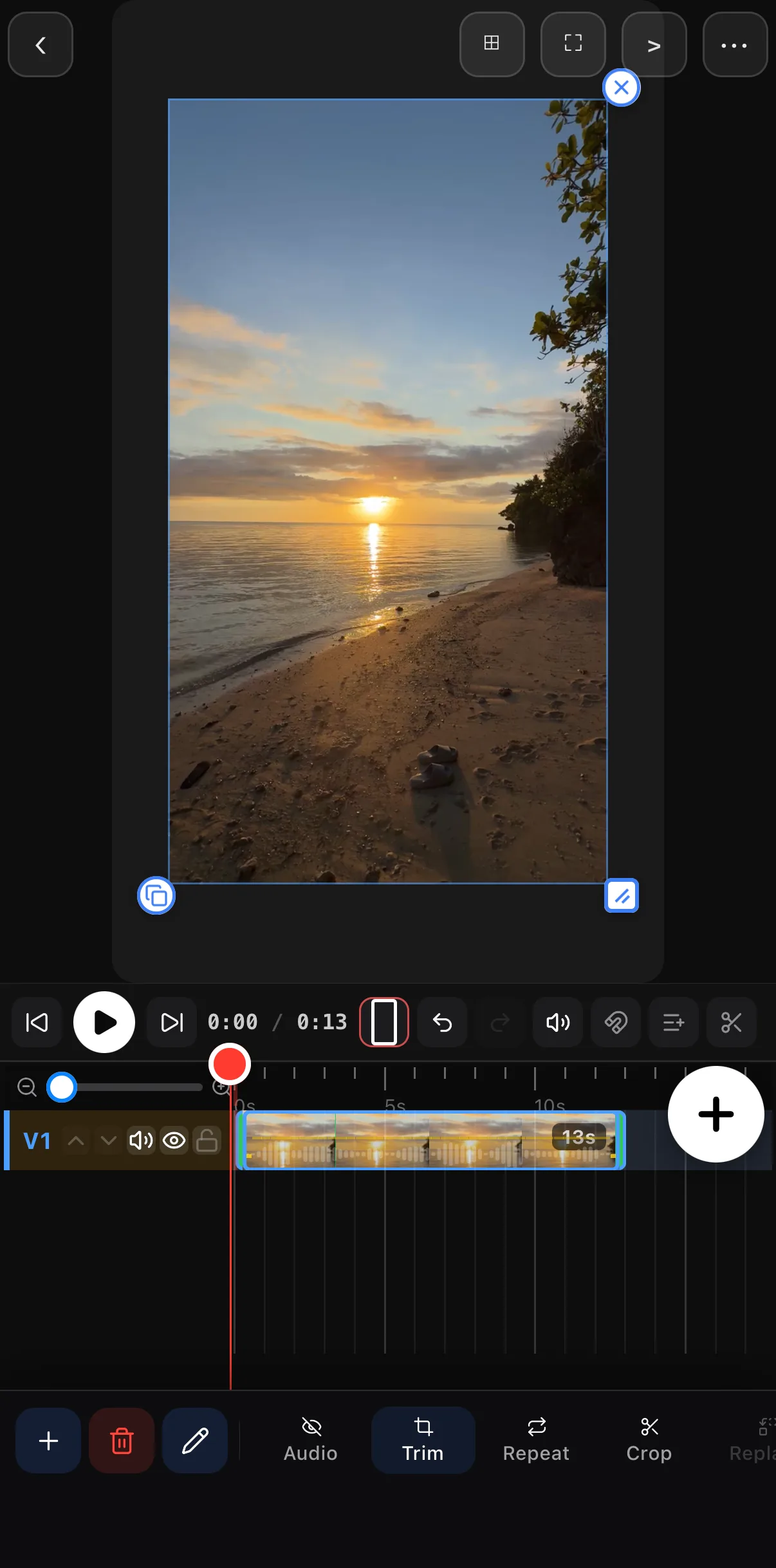 The editor with the beach clip selected on the timeline, trim handles on both ends, and the clip tools along the bottom