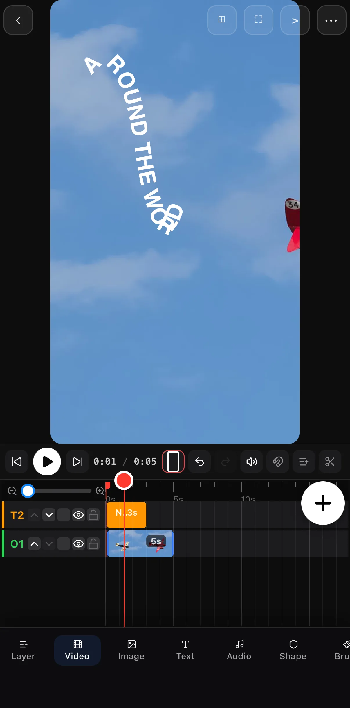 The canvas paused at 0:01: the letters of AROUND THE WORLD are strung down the first bend of the wave, bunching where the curve turns, with the text clip on T2 above the photo on O1.