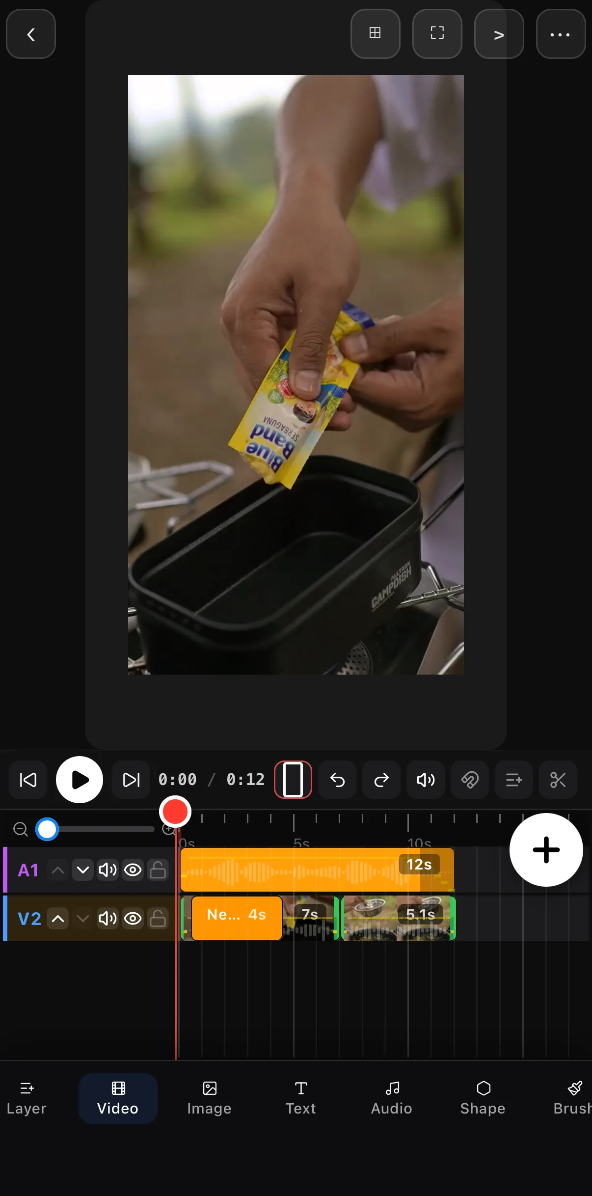 The Classic timeline under a camp-cooking clip: an A1 music row with a 12-second waveform above a V2 row holding a 4-second text clip and two video clips of 7 and 5.1 seconds, with + joiners between the videos.